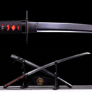 Close-up of sleek black katana with red and black hilt detail on black stand, featuring dragon emblem. Bleach Ichigo Bankai Katana.