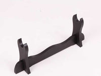 Sleek black katana stand with curved design, angled view on a white background, ideal for display. Sword Stand.